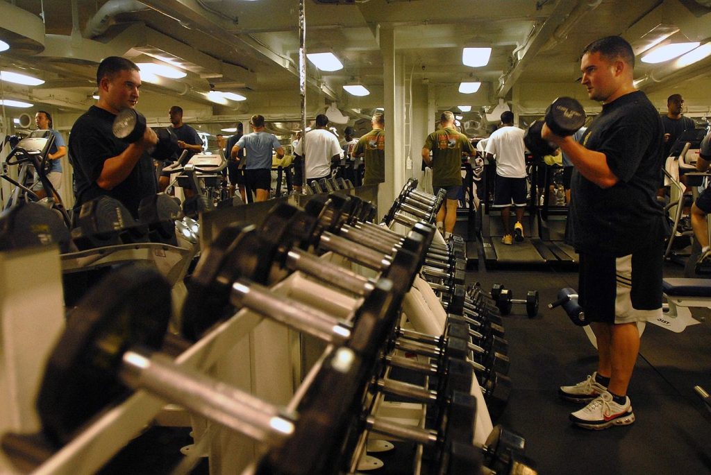 A person lifting dumbbells during a gym workout